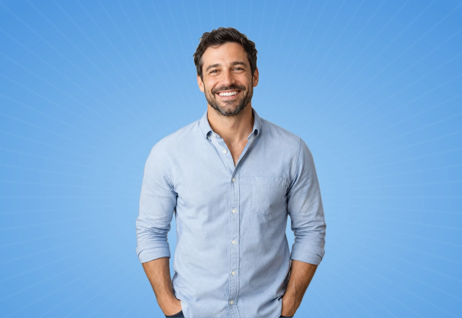 Smiling man in a blue shirt on a sky-blue background