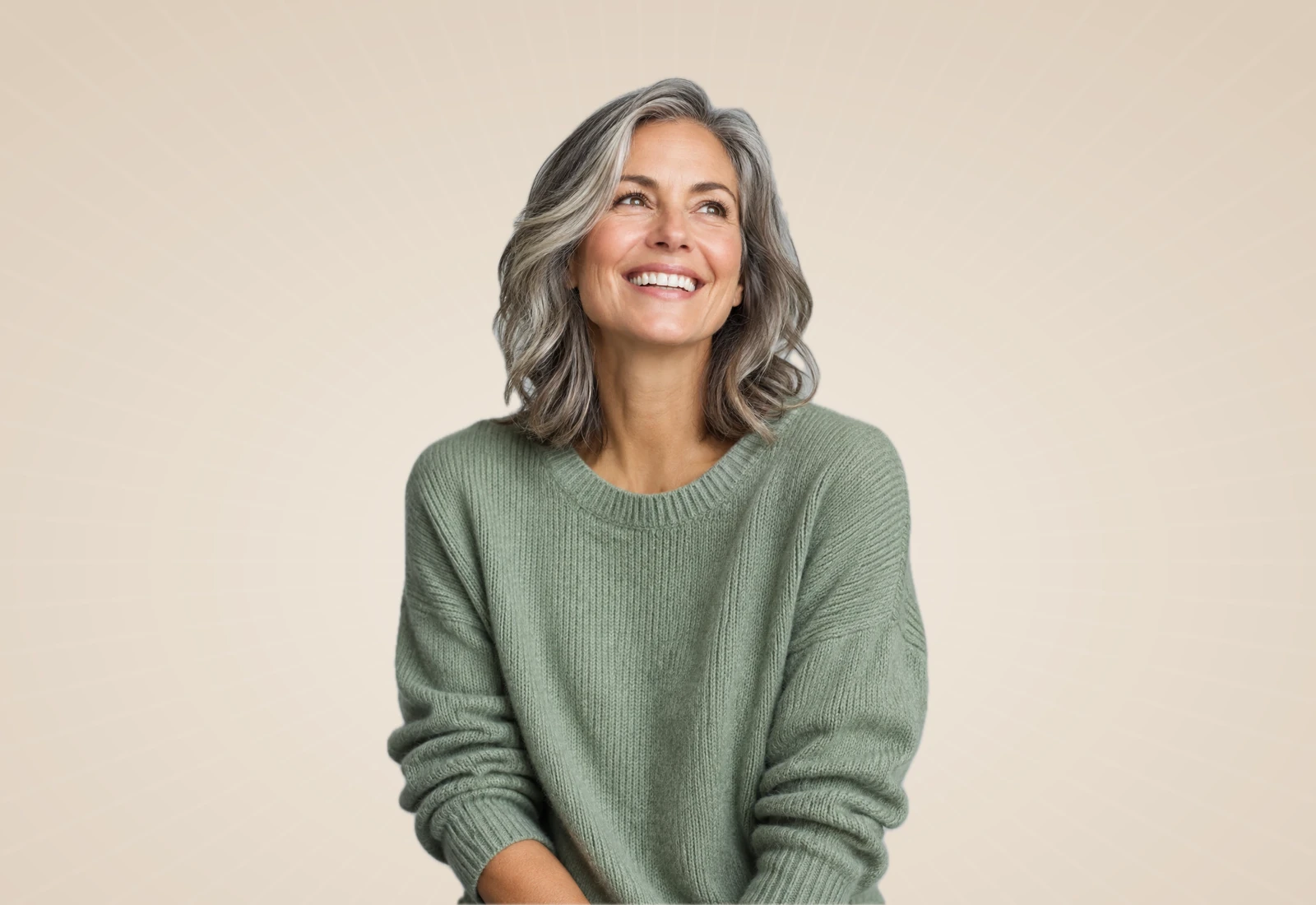 Smiling woman with silver hair on a warm neutral background